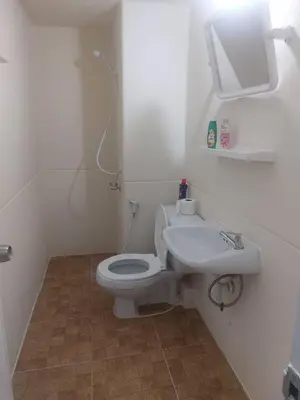 a bathroom with a white toilet and a sink at Solitude Skies14th Floor Studio in Nonthaburi