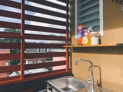 a kitchen with a sink and a window at The Giftown Bangkok, Talat Phlu in Thonhuri