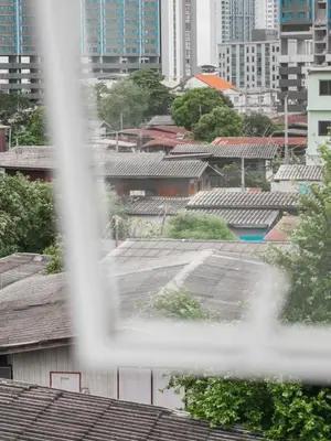 a view of a city through a fence at The Giftown Bangkok, Talat Phlu in Thonhuri