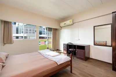 a room with a bed and a desk in it at Petch Tower Ekkamai in Bangkok
