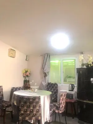 a dining room with a table and chairs and a window at Silver Room Guest House Very Close Bangkok Hospital in Bangkok