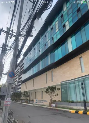 a large building with glass windows on the side of it at Silver Room Guest House Very Close Bangkok Hospital in Bangkok