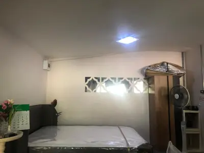 a small room with a bed in the corner at Silver Room Guest House Very Close Bangkok Hospital in Bangkok