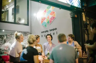 a group of people standing around in a restaurant at Everyday Bangkok Hostel in Bangkok