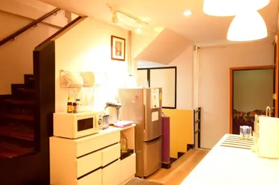 a kitchen with a refrigerator and a microwave at Room@Vipa in Bangkok