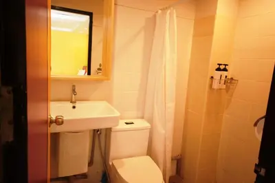 a bathroom with a toilet and a sink and a mirror at Room@Vipa in Bangkok