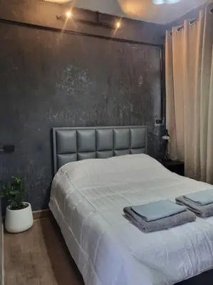 a bedroom with a bed with two towels on it at auntythong house in Bangkok