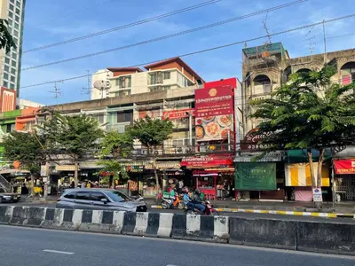 a city street with cars parked in front of buildings at 3A-168 House Near BTS-icon siam in Godown