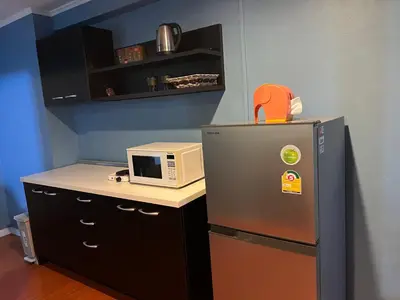 a kitchen with a refrigerator and a microwave on a counter at Regent Srinakarin 19A in Bangkok