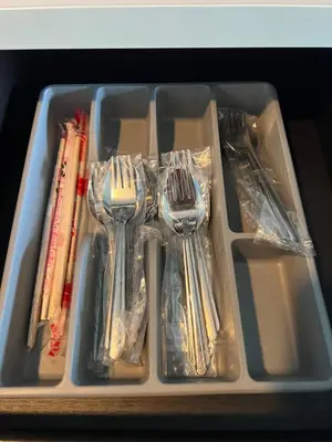 a tray of utensils in a drawer with forks at Regent Srinakarin 19A in Bangkok