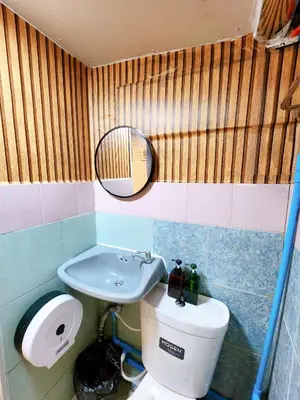 a bathroom with a sink and a toilet and a mirror at 110-Olan Place Homely room Free Wi-Fi and Near BTS line in Bangkok