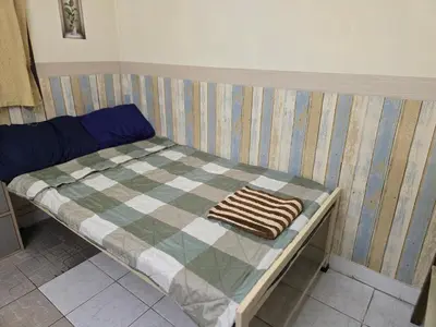 a small bed with a checkered blanket on it at J Place Studio 204 with nice fan free Wifi, near Skytrain in Bangkok