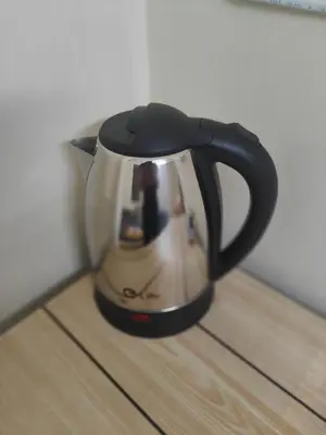 a black and white tea kettle sitting on a wooden floor at J Place Studio 204 with nice fan free Wifi, near Skytrain in Bangkok