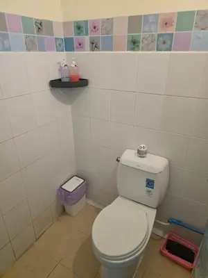 a bathroom with a white toilet in a room at J Place Studio 204 with nice fan free Wifi, near Skytrain in Bangkok