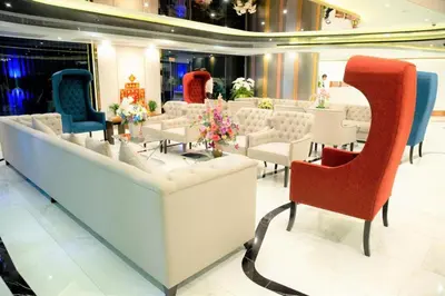 a room with chairs and tables in a store at First Pride Hotel Bangkok in Bangkok