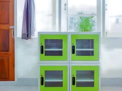 four green cabinets in a room with a window at Kamin Bird Hostel in Bangkok