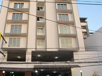 a tall white building with windows in front of it at Buddy Place in Bangkok