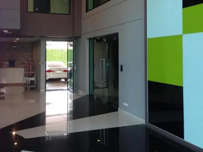a room with a hallway with a car in the background at Ipremium Sukhumvit 81 Hotel in Bangkok