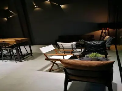 a living room with chairs and tables and a couch at sook station in Bangkok