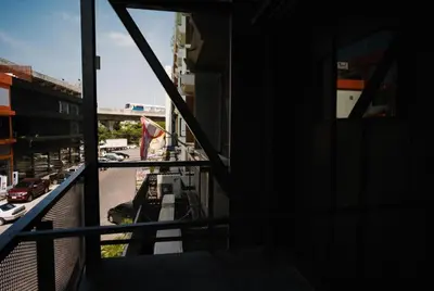 a view of a city street from a balcony at sook station in Bangkok