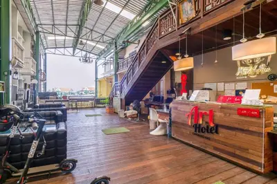 a restaurant with a lobby with a luggage counter and stairs at Art Hotel Sanamchai in Bangkok