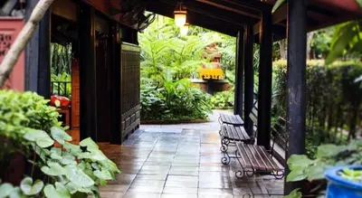 a patio with a bench and plants on a building at OYO 253 KK 11 Boutique Inn in Bangkok