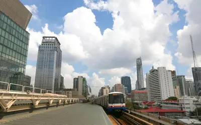 a train on a track in a city with buildings at OYO 253 KK 11 Boutique Inn in Bangkok