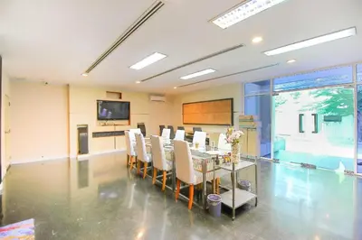a dining room with a table and chairs at OYO 1002 Pinklao Resort in Bangkok