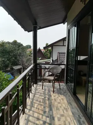 a balcony of a house with a table and a chair at Aiims Tales Canal Boutique House in Bangkok