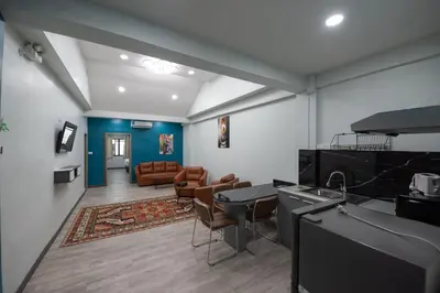 a room with a kitchen and a living room at SkyLink Homes - Pattunaam - Airport Link & BTS Chidlom in Bangkok