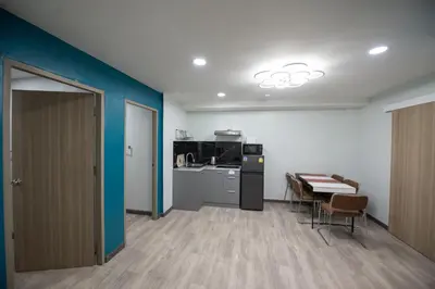 a room with a kitchen and a table and chairs at SkyLink Homes - Pattunaam - Airport Link & BTS Chidlom in Bangkok