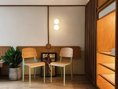a room with two chairs and a table with a picture at Parcel Hotel Bangkok in Bangkok