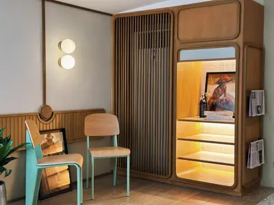 a dining room with a chair and a cabinet at Parcel Hotel Bangkok in Bangkok