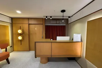an office with a desk and a red curtain at Parcel Hotel Bangkok in Bangkok