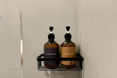 two bottles of wine sitting on a shelf in a refrigerator at Parcel Hotel Bangkok in Bangkok