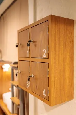 a row of wooden lockers on a wall at Rere Hostel - รีรีโฮสเทล in Bangkok