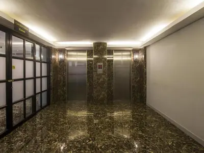 a hallway with a elevator in a building at First House Hotel in Bangkok