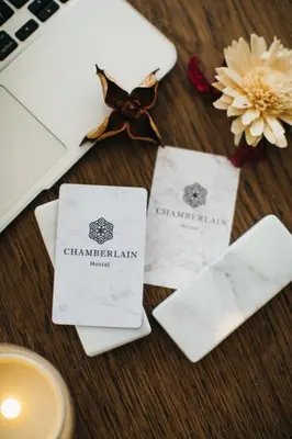 a table with two white napkins and a cup of coffee at Chamberlain Bangkok in Bangkok