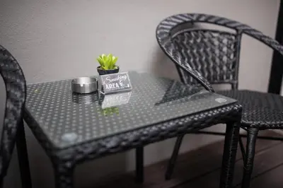 a black table with a plant on top of it at The Valen Resort in Bangkok