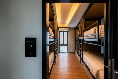 a hallway with four bunk beds in a hostel at Hostel De Kaya in Bangkok