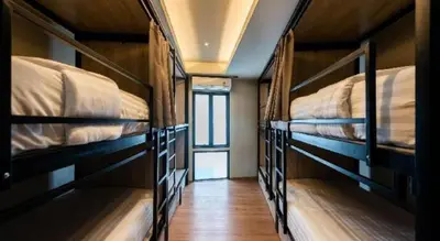 a room with three bunk beds in a room at Hostel De Kaya in Bangkok
