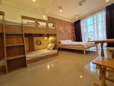 a room with two bunk beds and a table at De Chalet in Bangkok