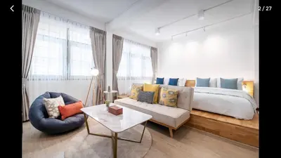 a bedroom with a bed and a couch and a table at 168 House 3B Near BTS iconsiam in Godown