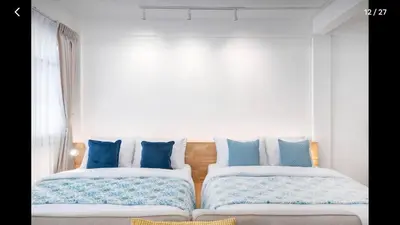 a bedroom with two beds with blue and white pillows at 168 House 3B Near BTS iconsiam in Godown