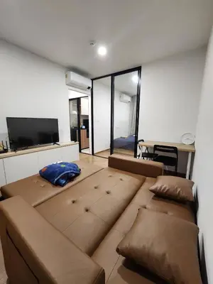 a living room with a large couch and a tv at Cozy Downtown Apartment - long stay in Bangkok- MRT Phasi charoen in Bangkok