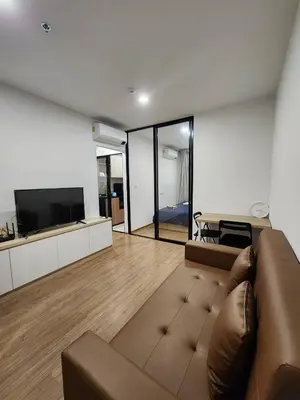 a living room with a couch and a television at Cozy Downtown Apartment - long stay in Bangkok- MRT Phasi charoen in Bangkok