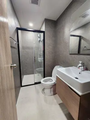 a bathroom with a shower and a toilet and a sink at Cozy Downtown Apartment - long stay in Bangkok- MRT Phasi charoen in Bangkok