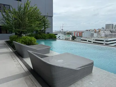 a swimming pool on the roof of a building at Cozy Downtown Apartment - long stay in Bangkok- MRT Phasi charoen in Bangkok
