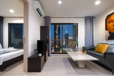a living room with a couch and a tv in a room at Luxury Art apt Downtown Metro Bangkok-Kitchen-living room in Bangkok