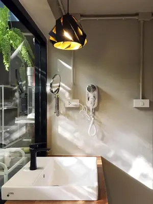 a bathroom with a sink and a mirror at Monomer Hostel Bangkok in Bangkok